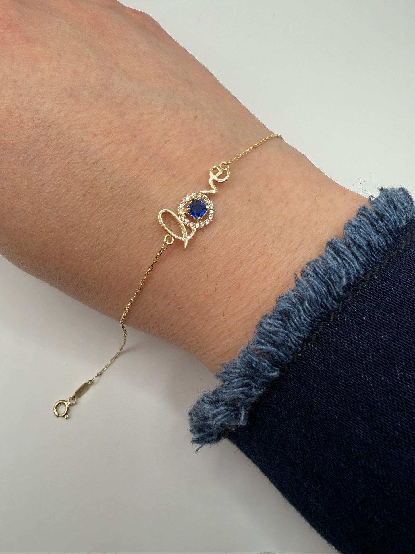 Pulsera Love con piedra azul en oro de 14k", size 7.5-8